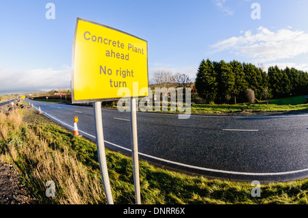 Sign at a construction site warning of a concrete plant ahead, and no right turn Stock Photo