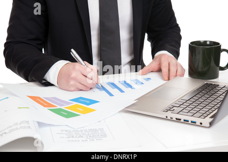 Businessman analyzing data on office desk Stock Photo