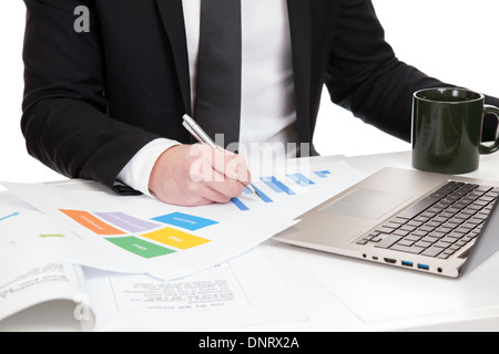 Businessman analyzing data on office desk Stock Photo