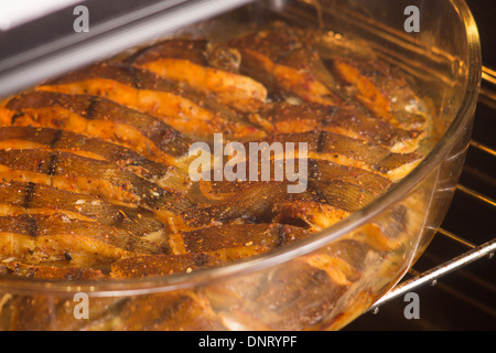 Cooked fish with spices baked in oven Stock Photo