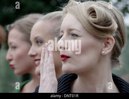 Girls in 1950s dress posing at Goodwood race course Stock Photo