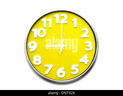 yellow clock face 9 o'clock the clock strikes nine 21.00 hours Stock Photo