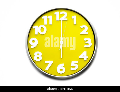 yellow clock face 6 o'clock the clock strikes six 1800 hours Stock Photo