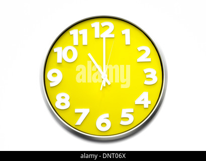 yellow clock face 11 o'clock Stock Photo