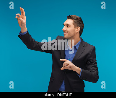 man in suit working with something imaginary Stock Photo