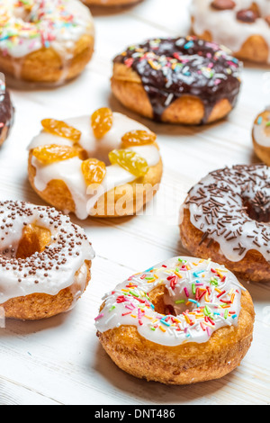 Colorful sweet freshly baked donuts with creamy topping Stock Photo - Alamy