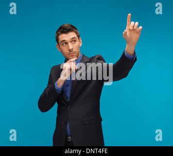 man in suit working with something imaginary Stock Photo