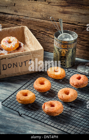 Donuts with powdered sugar on cooling rack Stock Photo