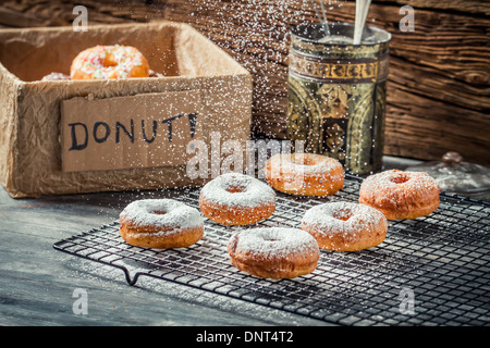 Closeup of falling powder sugar on donuts Stock Photo