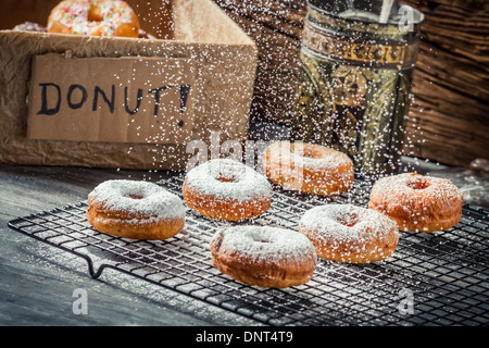 Falling powder sugar on donuts Stock Photo