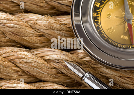 compass with ink pen on ship ropes Stock Photo