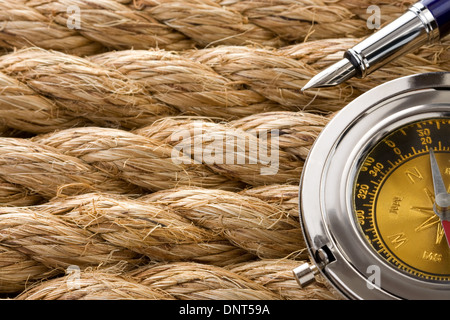 compass with ink pen on ship ropes Stock Photo
