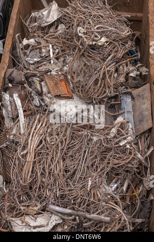 Scrap metal in a recycling container Stock Photo
