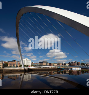 A daytime view in summer of Gateshead Millennium Bridge looking across the River Tyne towards Newcastle Stock Photo