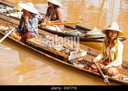 Vendors in selling trinkets sit in their long boats seeking the attention of tourists on November 3, 2013 on Inle Lake, Myanmar Stock Photo