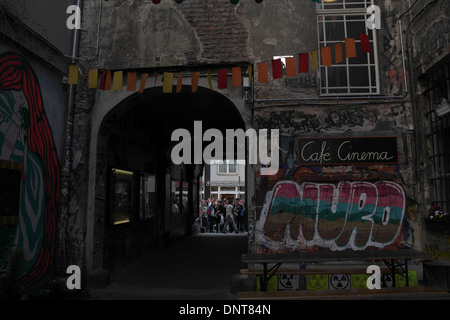 View, towards archway to Rosenthaler Strasse, yellow orange bunting flags over Graffiti Alley, Rosenthaler Strasse 39, Berlin Stock Photo