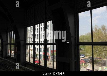 Sunny view dark metal-work Ostbahnhof (East Railway Station) windows to white building shops at Erich Steinfurth Strasse, Berlin Stock Photo