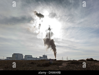 Steam train passing Dungeness Nuclear Power Station Stock Photo