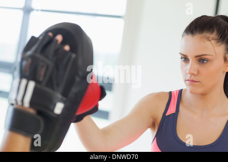 Determined female boxer focused on her training Stock Photo