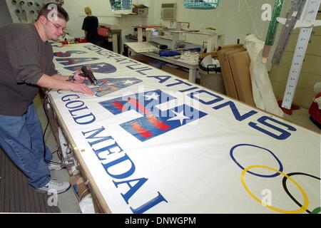 Feb. 22, 2002 - Great Neck, NY, USA - 2/22/02 Great Neck L.I. Sign-O-Rama in Great Neck prepares welcome home banner for gold medal winner Sarah Hughes. Graphic artist Michael Mahig working on the finishing touches of the 4 foot by 17 foot banner.( Neil Schneider). Neil Schneider/(Credit Image: © Globe Photos/ZUMAPRESS.com) Stock Photo