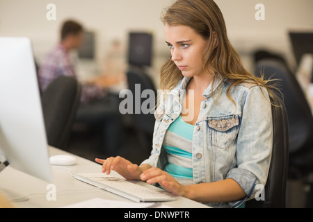 Focused young student working in the computer room Stock Photo
