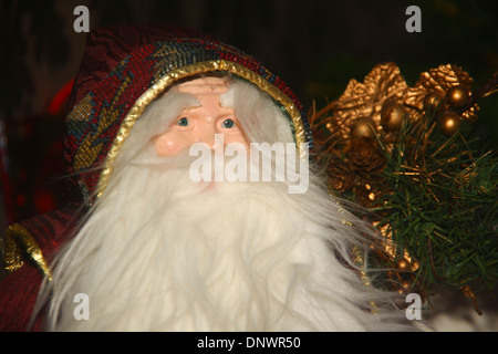 Decorative Santa Claus ornament under Christmas tree UK Stock Photo