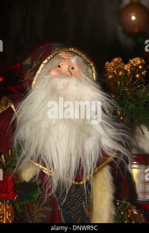 Decorative Santa Claus ornament under Christmas tree UK Stock Photo
