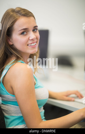 Happy student smiling at camera in the computer room Stock Photo