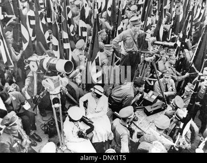 Jan. 1, 1934 - Nuremberg, Germany - Controversial film-maker LENI RIEFENSTAHL (center, in a white dress) pictured during shooting the Nazi propaganda film Triumph of the Will, a documentary glorifying Hitler and widely regarded as one of the most effective pieces of propaganda ever produced. She became a favourite of German dictator Adolf Hitler in the 1930s, making films for his f Stock Photo
