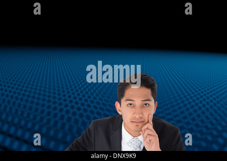 Composite image of thoughtful asian businessman pointing Stock Photo