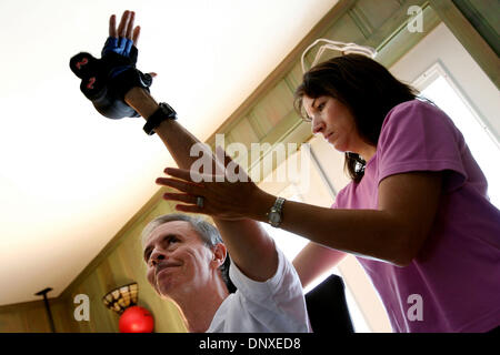 Dec 07, 2005; West Palm Beach, FL, USA; Don Chester, with occupational therapist Leigh Ann Agee, works out with four pound weights at his home in West Palm Beach. Don, a triathlete was paralyzed after being struck by a car while training Dec. 24, 2004. Always the athlete he is constantly pushing himself to get stronger. Mandatory Credit: Photo by Gary Coronado/Palm Beach Post /ZUMA Stock Photo