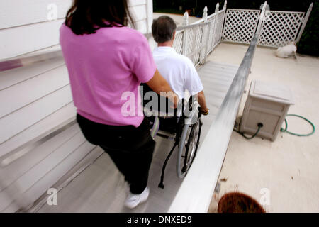 Dec 07, 2005; West Palm Beach, FL, USA; Don Chester, with occupational therapist Leigh Ann Agee, helps Don roll himself down a ramp on a non-motorized wheel chair at his home in West Palm Beach. Don, a triathlete was paralyzed after being struck by a car while training Dec. 24, 2004. Mandatory Credit: Photo by Gary Coronado/Palm Beach Post /ZUMA Press. (©) Copyright 2005 by Palm Be Stock Photo