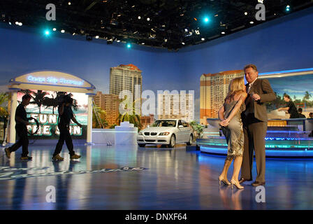 Dec 10, 2005; Ft. Lauderdale, FL, USA; When Wheel of Fortune co-host Vanna White's microphone isn't working as they step onstage, Pat Sajak offers her the one attached to his jacket during taping of the show's first 'Fun In The Sun' segment at the Broward County Convention Center in Ft. Lauderdale Saturday, Dec. 10, 2005. Shows from the Ft. Lauderdale taping will air in mid-Februar Stock Photo