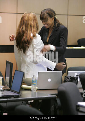 Dec 12, 2005; West Palm Beach, FL, USA; Venus  Williams right laughs and then hugs her siter Serena Williams during a morning recess in Judge Jeffrey Winikoff's courtroom  Monday. The Williams sisters and their father are defendants in a lawsuit contending that Richard Williams committed them to playing in the proposed 'Battle of the Sexes' tournament. The lawsuit, seeking unspecif Stock Photo