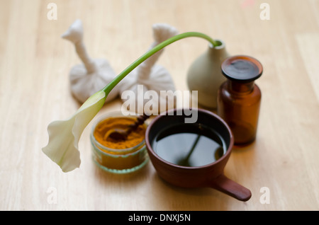 A table top arrangement of spice, oil and massaging tools, used in Ayurveda massage. Stock Photo