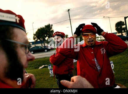 Dec 22, 2005; Ft. Pierce, FL, USA; (L-R) Chapter Leader Steve 'Crusader' Horton, Jonny 'Blade' Portnoy, and Mark 'Lifeguard' Peterson, all of Port St. Lucie and Fort Pierce, check their hats and uniforms before heading to the picket line Thursday on US Federal Hwy 1 outside of Pleasure Cove mobile home park in Fort Pierce. The Guardian Angels Treasure Coast Chapter joined Judith Su Stock Photo