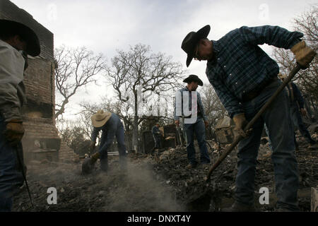 Dec 28, 2005; Cross Plains, TX, USA; Aaron Rogers, from left, Johnny Cleveland and Creath Switzer, all of Blanket, TX, help homeowner Allan Key, right, look for salvagable items in the remains of his home after a grass fire in Cross Plains, TX on Wednesday, December 28, 2005. Mandatory Credit: Photo by L. Krantz/San Antonio Express-News /ZUMA Press. (©) Copyright 2005 by San Antoni