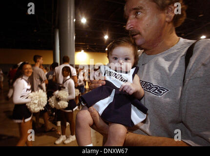 Jan 02, 2006; Miami Beach, FL, USA; Nittany Lions fan ALANA JONES, 4 months, with her dad, ED JONES, during a pep rally at the Miami Beach Convention Center on Jan. 2, 2005. Penn State boasts the largest alumni organization in the country and thousands of the party faithful flocked to the convention center to see the team, hear the Blue Band and scream with the cheerleaders in anti Stock Photo