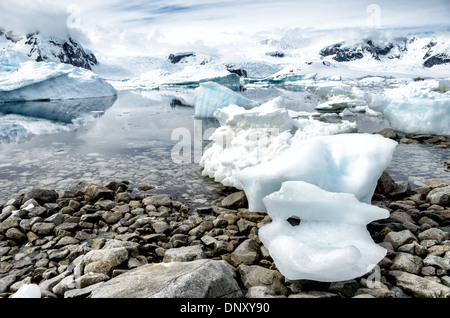 ANTARCTICA - Blocks of Antarctic sea ice washed ashore on the rocky beach at Cuverville Island on the Antarctic Peninsula. Stock Photo