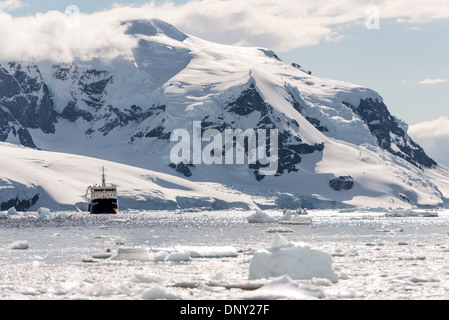 ANTARCTICA - A ship (Polar Pioneer) amongst the brash ice and icebergs of Neko Harbour, Antarctica. Stock Photo