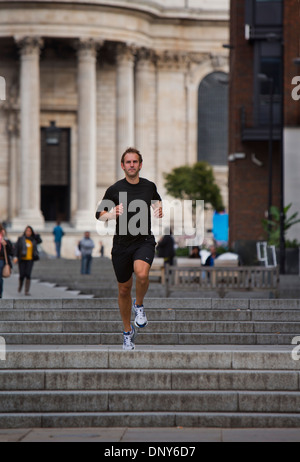 Gary Hicking, personal trainer in London, UK, keeping fit by jogging through the city. Stock Photo