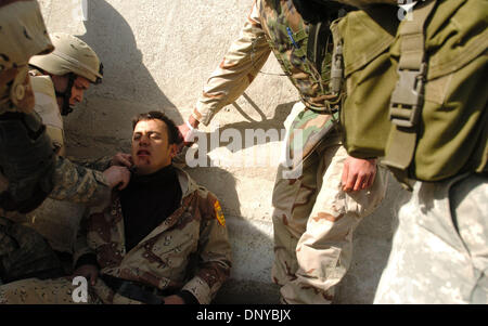 Jan 22, 2006; Abu Ghraib, Iraq; American Soldiers Protect An Iraqi 