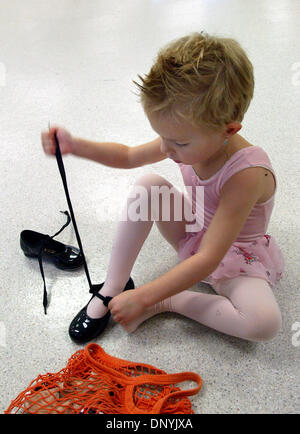 Feb 01, 2006; Boca Raton, FL, USA; 3-Year-old Jacklyn Lipp, 3, unties her tap shoes as she prepares for the ballet portion of her dance class, Wednesday afternoon with Miss Irene. Jacklyn was among 11 girls ages 3 and 4 taking the weekly class at the Boca Raton Community Center. The girls learn steps and routines they will perform at a recital in June.  Mandatory Credit: Photo by B Stock Photo