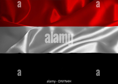 Yemen flag on satin texture. Stock Photo
