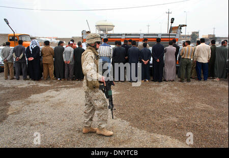 Feb 08, 2006; Al-Falujah, IRAQ; A marine from Weapons company 2nd marine division, 2nd battalion, 6th marine regiment, RCT-8, 4th platoon (callsign Black Label) stands guard over a group of military aged Iraqi males during a search for insurgents in the Iraqi city of Al-Falujah. Mandatory Credit: Photo by Toby Morris/ZUMA Press. (©) Copyright 2006 by Toby Morris Stock Photo