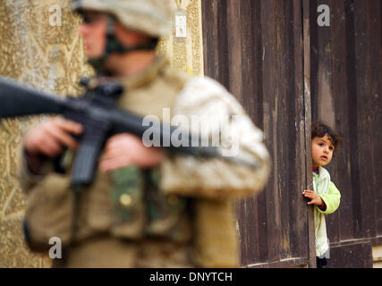 Feb 08, 2006; Al-Falujah, IRAQ; A little girl peaks out from the gateway to her home as marines from Weapons company 2nd marine division, 2nd battalion, 6th marine regiment, RCT-8, 4th platoon (callsign Black Label) patrols her neighborhood in the Iraqi city of Al-Falujah. Mandatory Credit: Photo by Toby Morris/ZUMA Press. (?) Copyright 2006 by Toby Morris Stock Photo