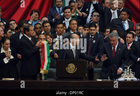 Dec 01, 2006 - Mexico City, Mexico - Mexican President VICENTE FOX (left) prepares to pass the presidential sash to succesor FELIPE CALDERON (center) during a raucous inauguration ceremony in the Mexican Congress in Mexico City.  (Credit Image: © Luis J. Jimenez/ZUMA Press) Stock Photo