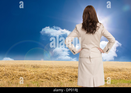 Composite image of businesswoman standing back to camera Stock Photo