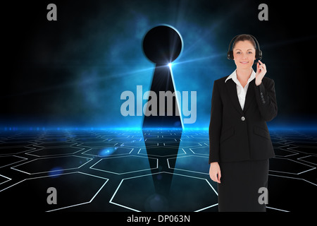 Composite image of good looking woman in suit using headphones and posing Stock Photo