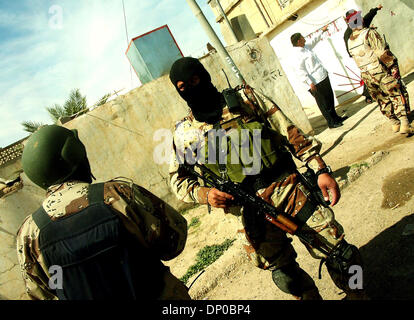 Mar 07, 2006; Ad Dawr, Saluhidin, IRAQ; Iraqi soldiers talk during a search of a neighborhood in Ad Dawr, Iraq, for an insurgent sniper. The sniper shot and wounded one American soldier before getting away. The soldier lived and was evacuated to Germany. Ad Dawr is approximately 15 miles from Tikrit and 15 miles from Samarra. 2nd of the 9th Cavalry is deployed to Iraq from Fort Car Stock Photo